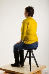 Sitting reference of yellow sweater blue jeans Gwendolyn